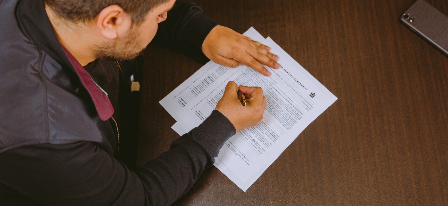 An Unusual Market Blogpost Hero Image- Homebuyer signing papers 